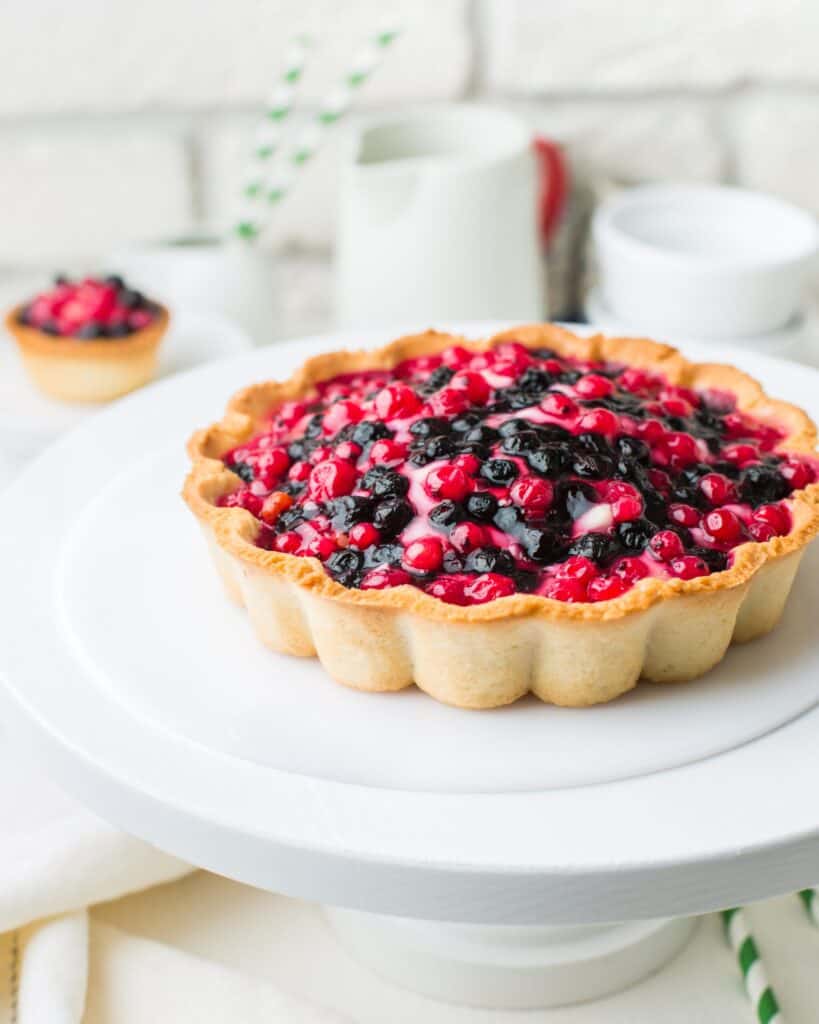 berry tart on a white cake stand