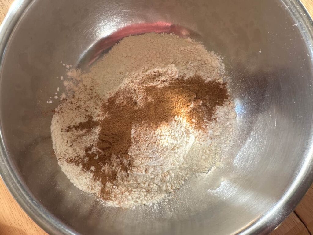 dry ingredients of the peach butter quick bread in a stainless steel bowl