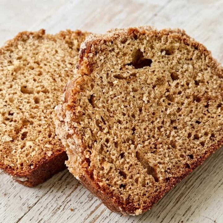 2 slices of peach butter loaf cake on a wooden cutting board