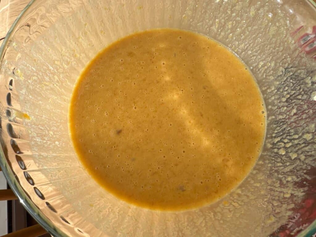 wet ingredients of the peach butter quick bread batter in a glass bowl