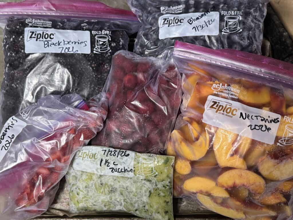 freezer bags of frozen blackberries, strawberries, shredded zucchini, raspberries, blueberries, and sliced nectarines