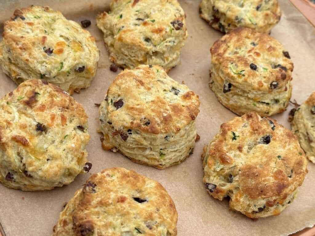parchment lined baking tray of ready to eat bacon cheddar zucchini biscuits